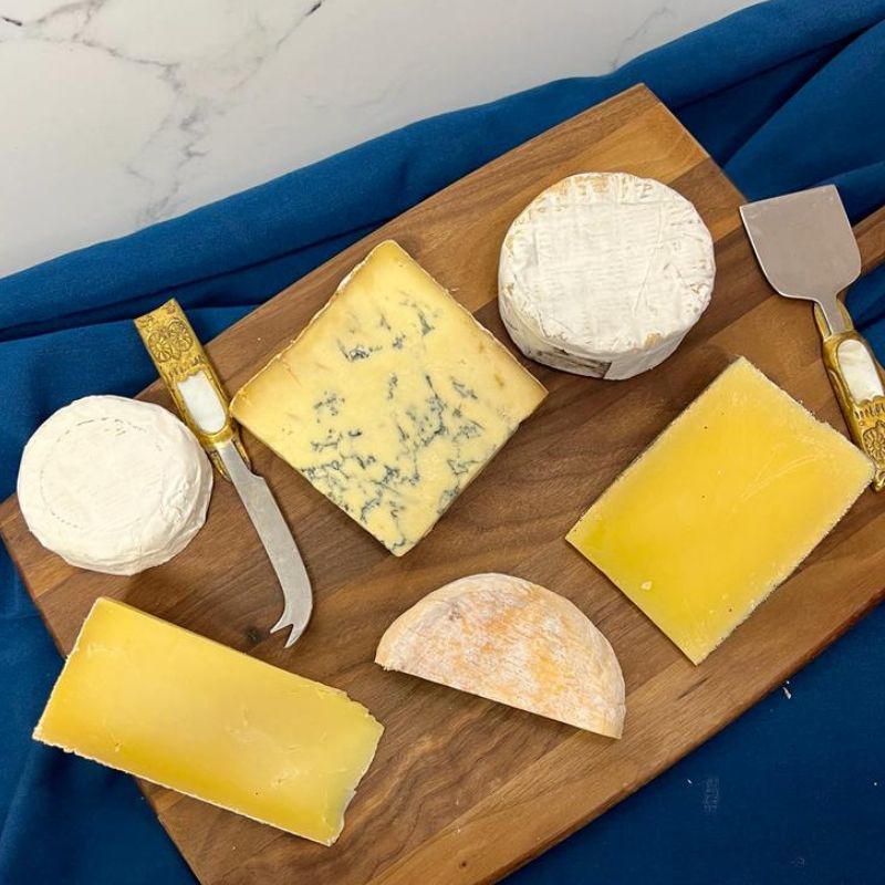 british farmhouse and artisanal cheese montgomery's cheddar, yarlington, winslade cheese, colston bassett stilton , little lilly, and cheese knife 