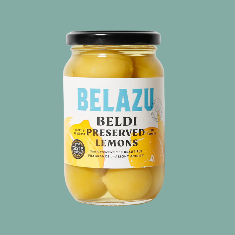 Jar of Belazu preserved lemons on a teal background