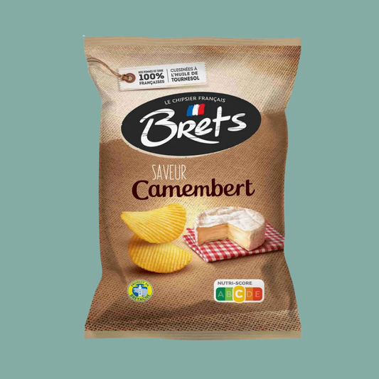A bag of Brets Camembert potato chips on a solid teal background. The packaging is a textured brown burlap style with a black oval logo containing the white 'Brets' brand name.