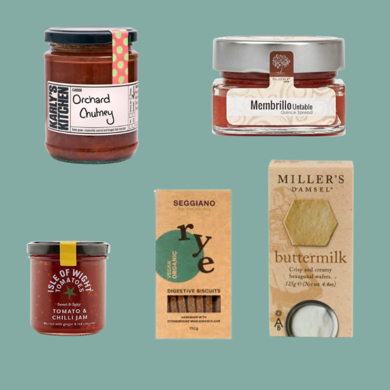 A collage of five packaged food products on a flat sage-green background: a jar of Orchard Kitchen chumey, a small jar of Membrillo unbleached butter, a jar of Isle of Wight Tomato & Chilli Jam, a box of Seggiano Rye digestive biscuits, and a box of Miller's Damsel buttermilk.