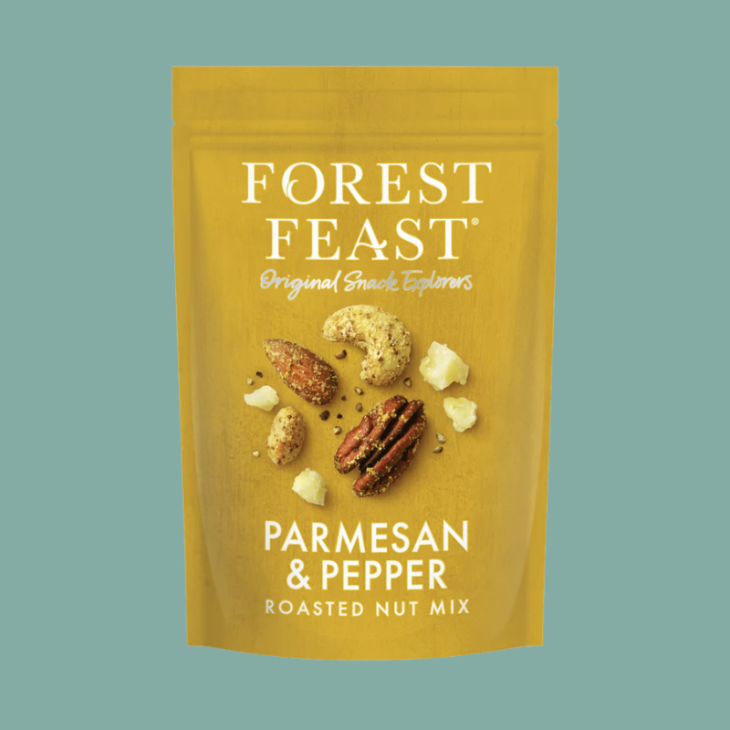 Forest Feast Parmesan & Pepper Roasted Nut Mix in a golden-yellow resealable pouch, featuring illustrations of almonds, pecans, and parmesan cheese pieces on the front, set against a solid teal background.