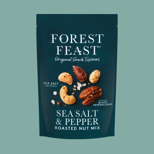 Forest Feast Sea Salt & Pepper Roasted Nut Mix in a dark teal stand-up pouch with white text and illustrations of mixed nuts and sea salt crystals on a solid muted green background.