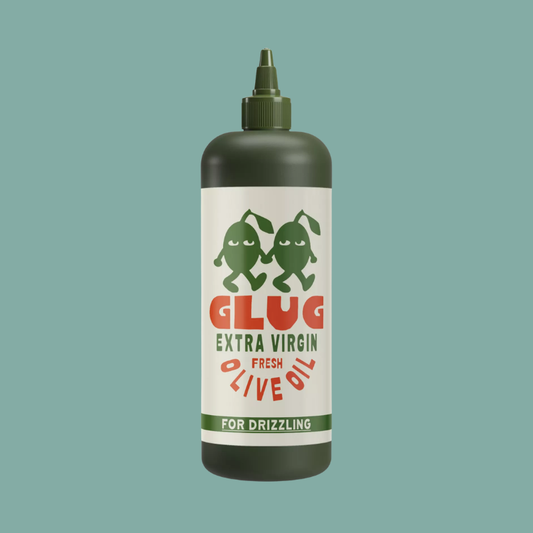 A dark olive green squeeze bottle of Glug Extra Virgin Fresh Olive Oil with a white label and green/red text, centered on a solid teal background.