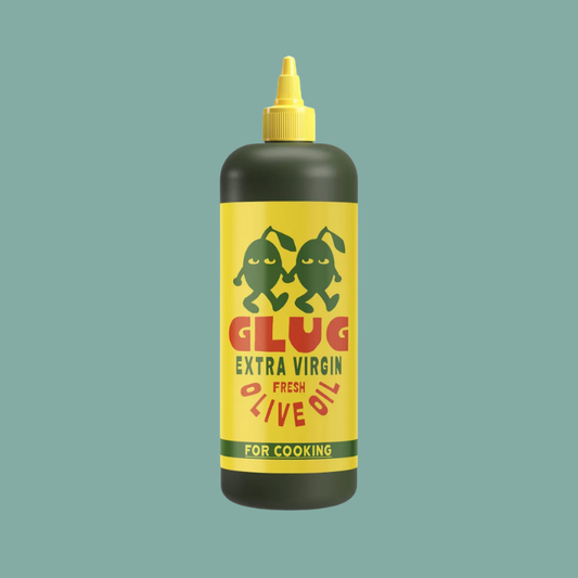 A squeeze bottle of Glug Extra Virgin Olive Oil for cooking, featuring a bright yellow label with two dancing green olives and bold red and green text, topped with a yellow cap, set against a solid teal background.