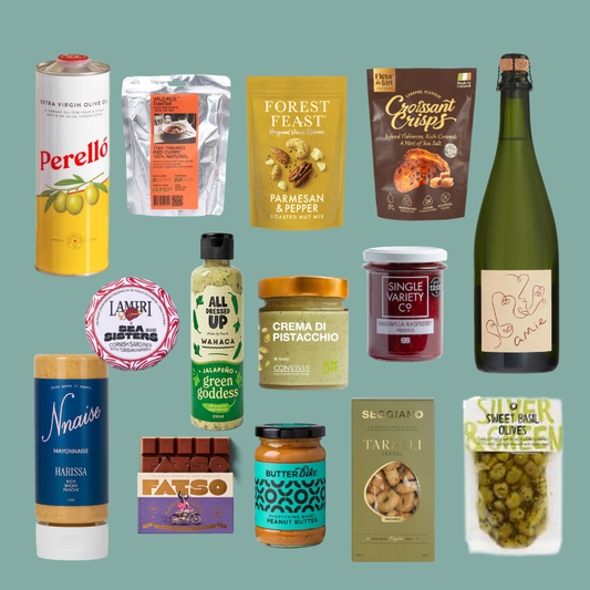 A collage of twelve different gourmet food products arranged on a solid muted teal background. The products include items from brands like Perello, Forest Feast, Crispin, Nvra, Lamiri, Fatso, Butter Rich, and Belliciano, shown in their retail packaging.