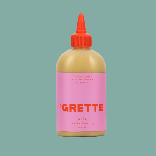 Bottle of 'Grette Dijon mustard on a teal background