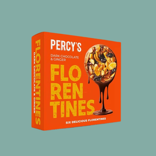 A boxed food product on a plain muted blue-green background. The package is bright orange with large yellow text reading 'FLORENTINES' and white text reading 'PERCY'S DARK CHOCOLATE & GINGER.