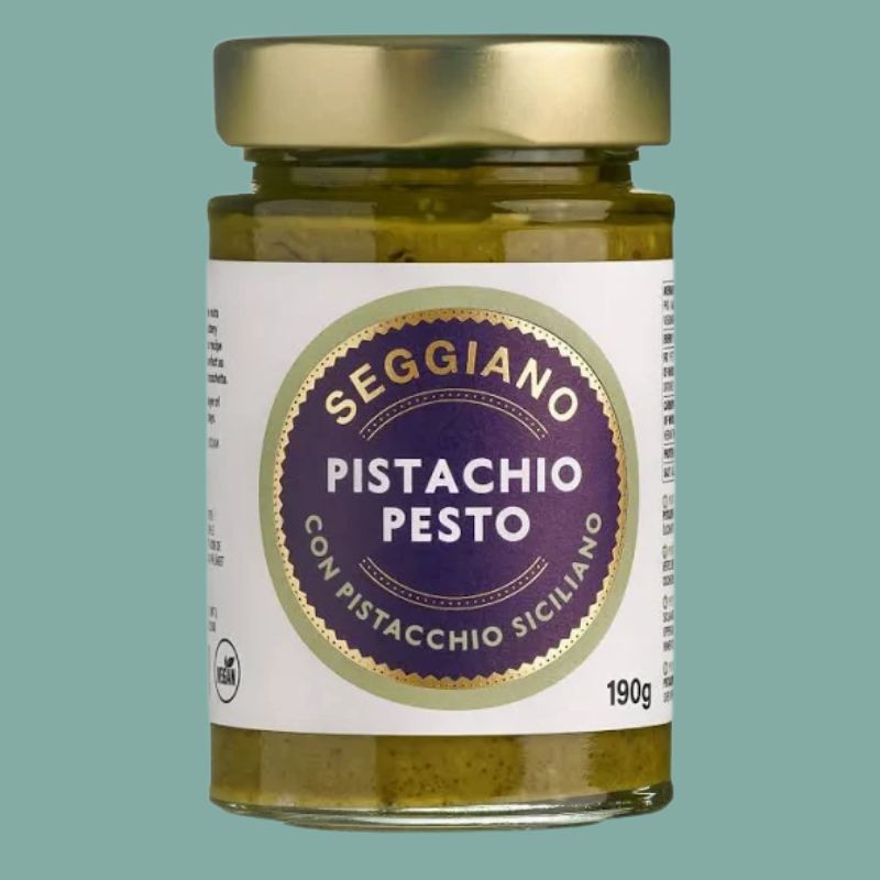 Jar of Seggiano Pistachio Pesto on a teal background