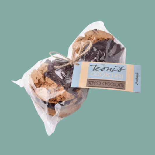 chocolate-dipped cookies tied with twine and attached to a paper tag reading 'Toni's Cookies Dipped Chocolate,' shown on a solid muted green background.