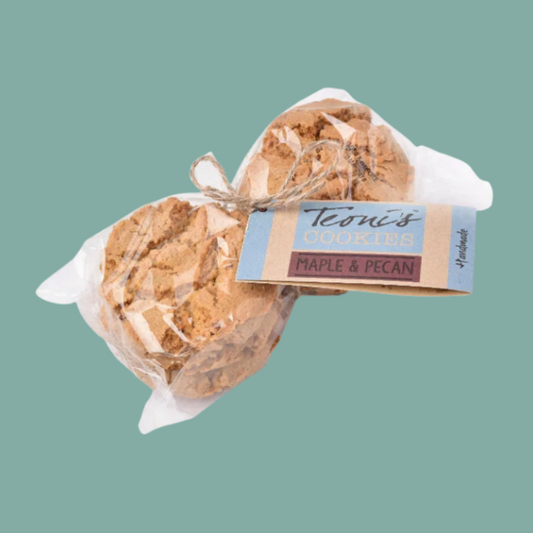 maple and pecan cookies tied with twine and labeled 'Teoni's Handmade Maple & Pecan' on a solid teal background.