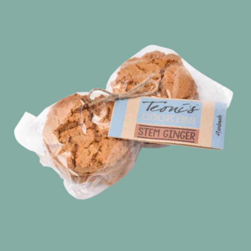 stem ginger cookies with a paper tag reading 'Teoni's Cookies Stem Ginger' on a solid teal background.