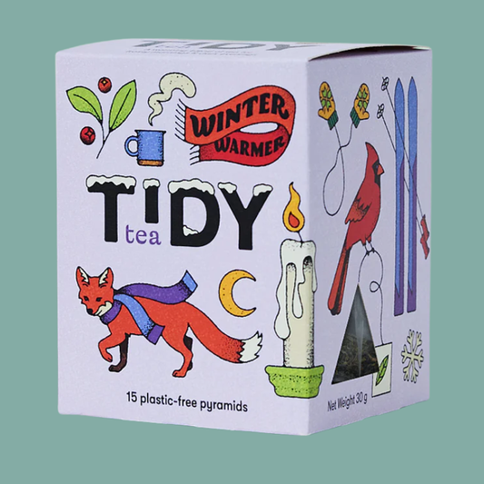 Tidy Tea packaging with illustrations of a fox, candle, and cardinal on a green background